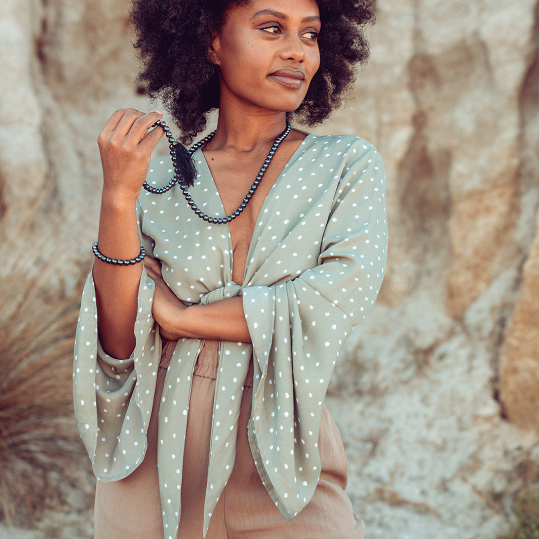 Woman looking away wearing Ambarya Strength - Hematite Mala Bead Set