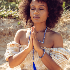Close up of woman with eyes closed with Ambarya Insight - Sodalite Mala Bead Set