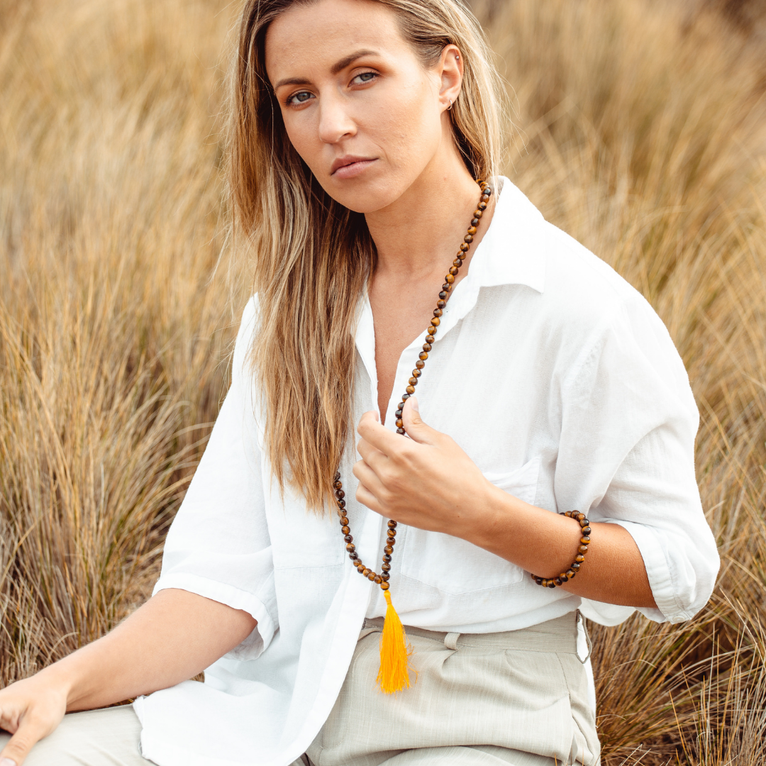 Woman wearing Tiger’s Eye crystal Mala Bead Set