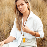 Woman wearing Tiger’s Eye crystal Mala Bead Set