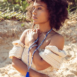 Close up of woman looking out wearing Ambarya Insight - Sodalite Mala Bead Set