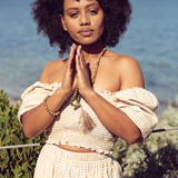 Woman with hands in prayer wearing Ambarya Harmony - Unakite mala bead set