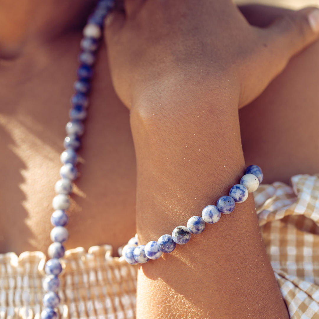 Close up of woman's wrist wearing Ambarya Insight - Sodalite Mala Bead bracelet