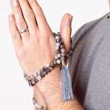 Man with Acceptance - Botswana Agate crystal Mala Bead Necklace wrapped around his hand