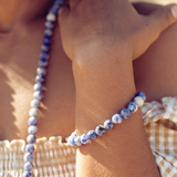 Close up of woman's wrist wearing Ambarya Insight - Sodalite Mala Bead bracelet