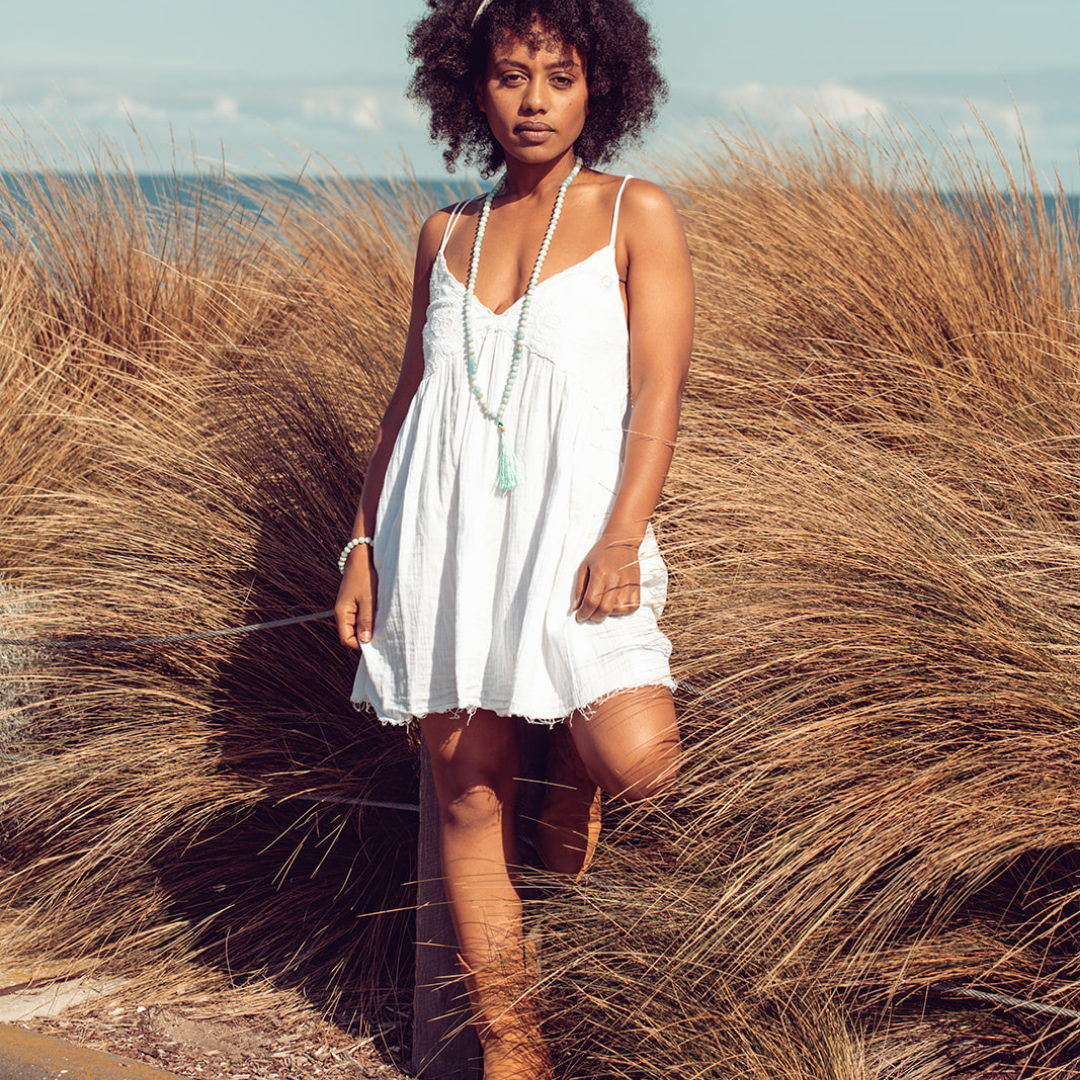 Woman standing in front of long grass wearing Ambarya Hope - Amazonite Mala Bead Set