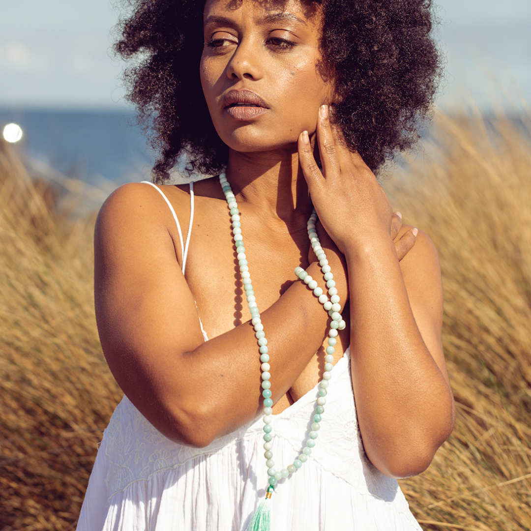 Woman looking away from the camera she is wearing Ambarya Hope - Amazonite Mala Bead Set