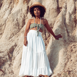 Woman looking into the distance, standing against rocks she is wearing Ambarya Patience - Howlite Mala Bead Set