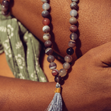 Close up of Ambarya Acceptance - Botswana Agate Mala Bead Necklace against a woman's skin