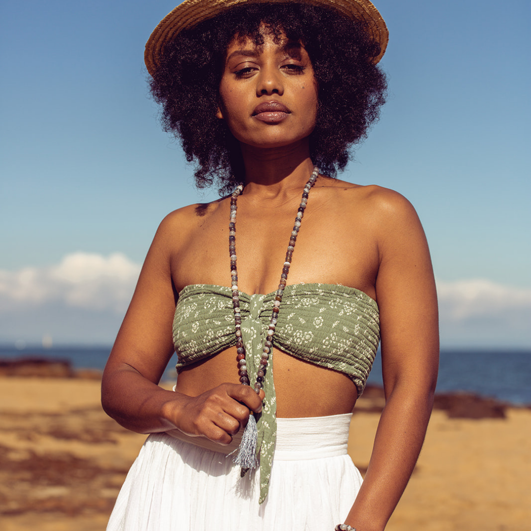 Woman at the beach wearing Ambarya Acceptance - Botswana Agate Mala Bead Necklace
